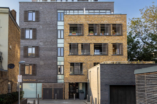 Contemporary brick apartment development with a set-back top floor