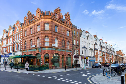 Victorian red-brick corner building on a London high street